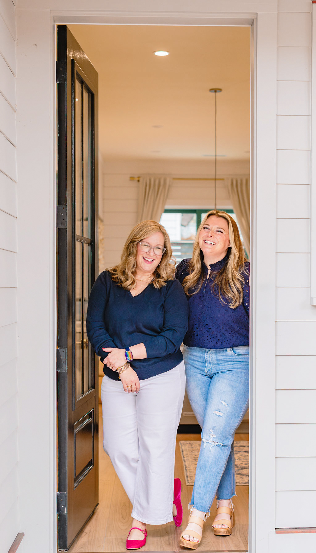 Woman entrepreneur journaling at a clean desk with a laptop and coffee, surrounded by notebooks and soft light—symbolizing business reflection and planning during a slow season.