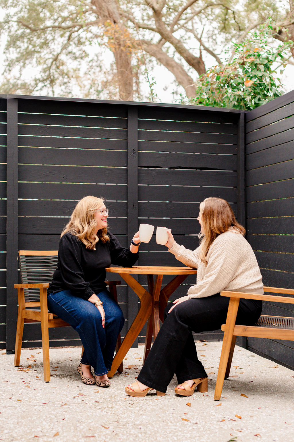 two women drinking coffee on an outdoor patio in charleston sc
