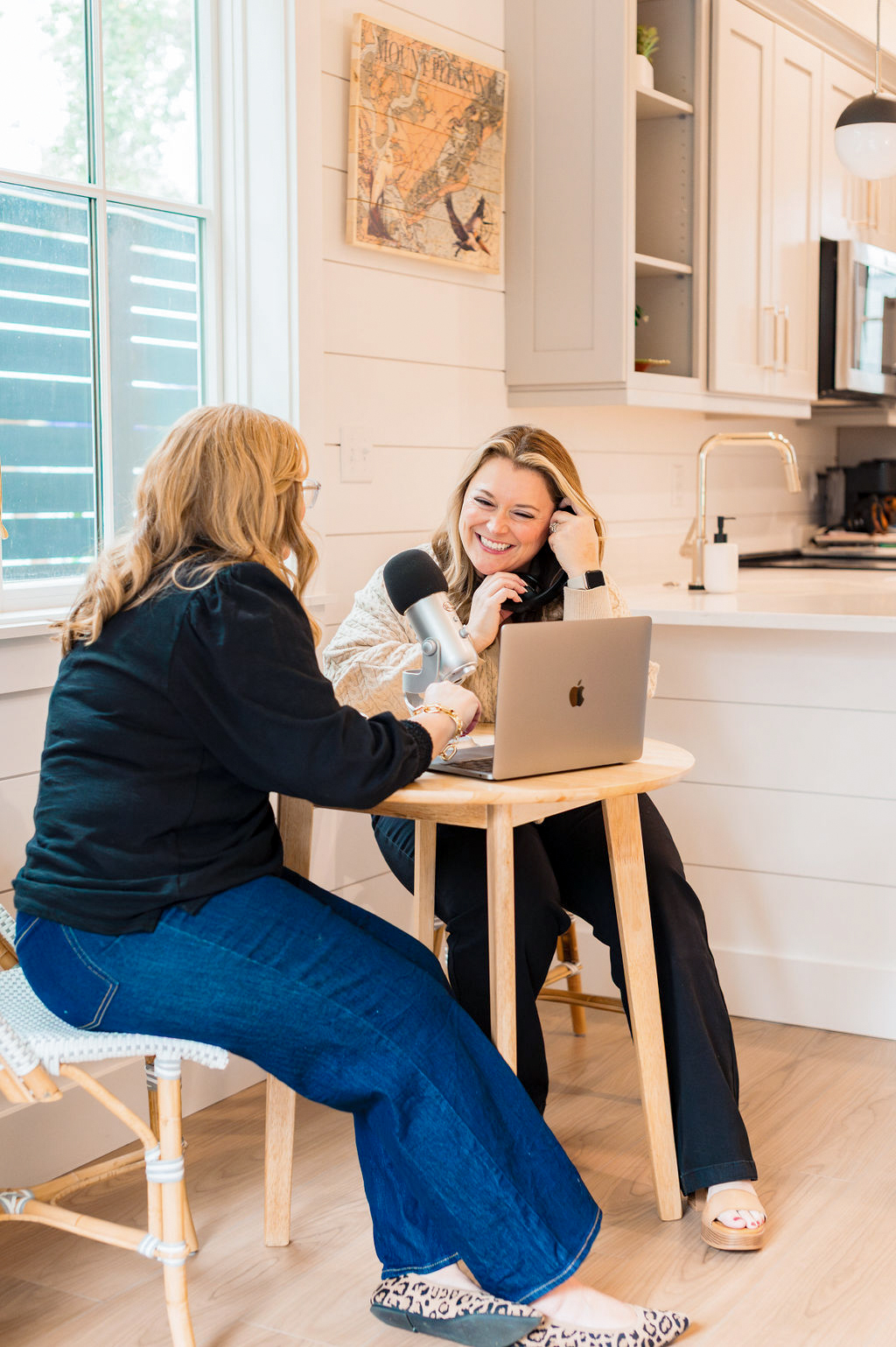 two women podcasting at a table